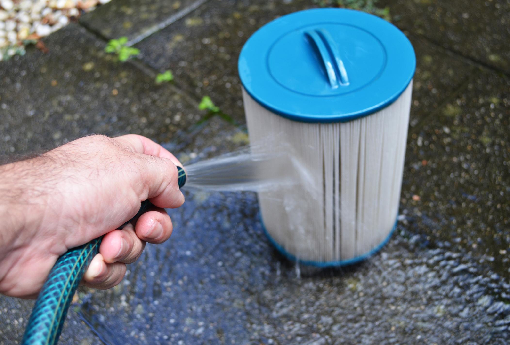 Person Hosing Off Water Filter
